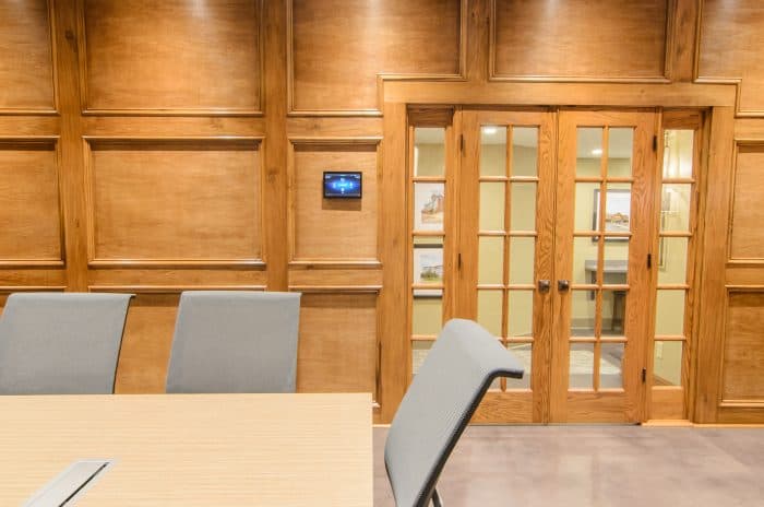 Conference room with a projection screen and a dedicated tabletop touchscreen controller