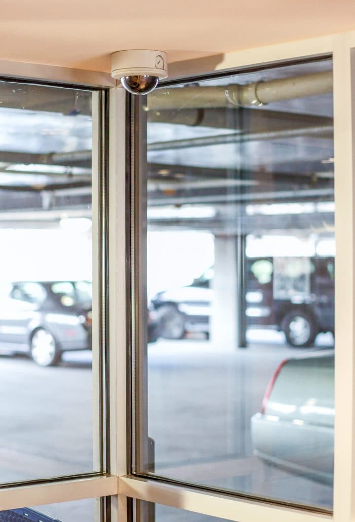 Security camera mounted at the entrance of a covered parking area